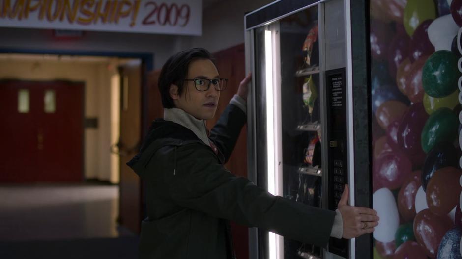 Brainy looks over at a teacher who has caught him at the vending machine.