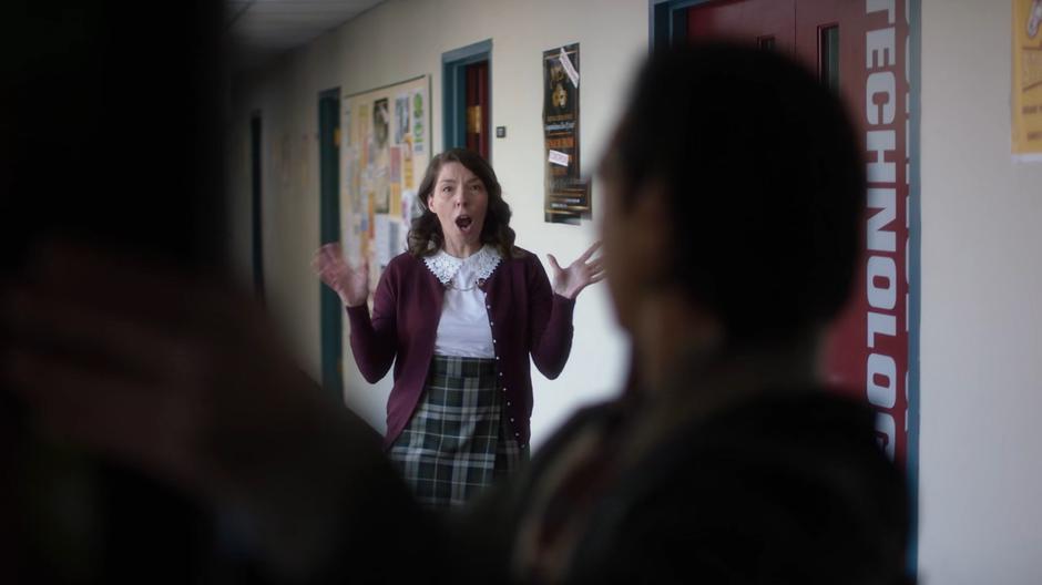 The Glee Club teacher looks excited to see Brainy in the hall.