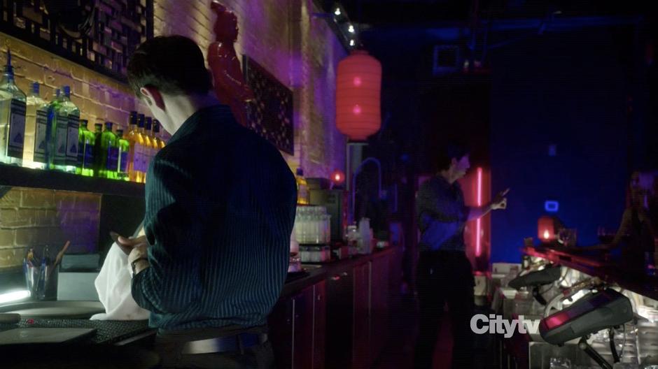 Johnny McKee cleans a knife at the bar.