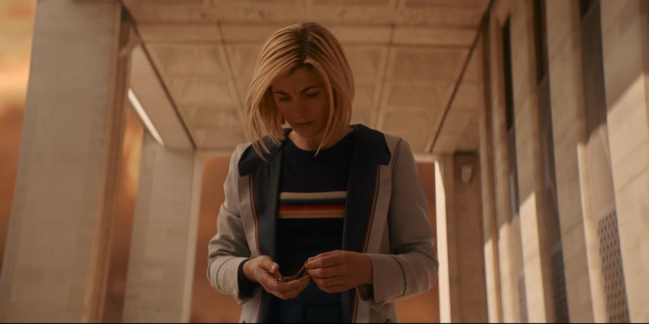 The Doctor looks down at the fob watch containing her lost memories.