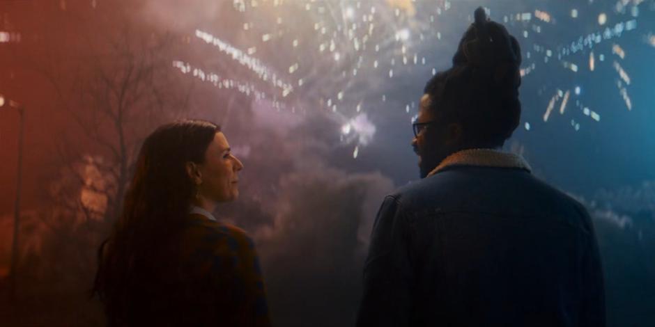 Sarah and Nick share a look as fireworks explode from the remains of the building.