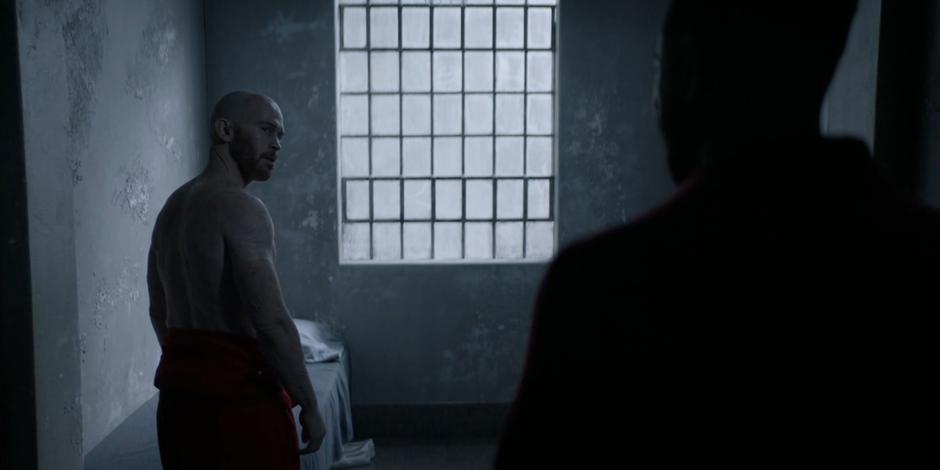 Victor Zsasz turns as Marquis steps into his cell.