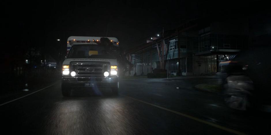 Ryan lands on the windshield of the ambulance as it races down the street.