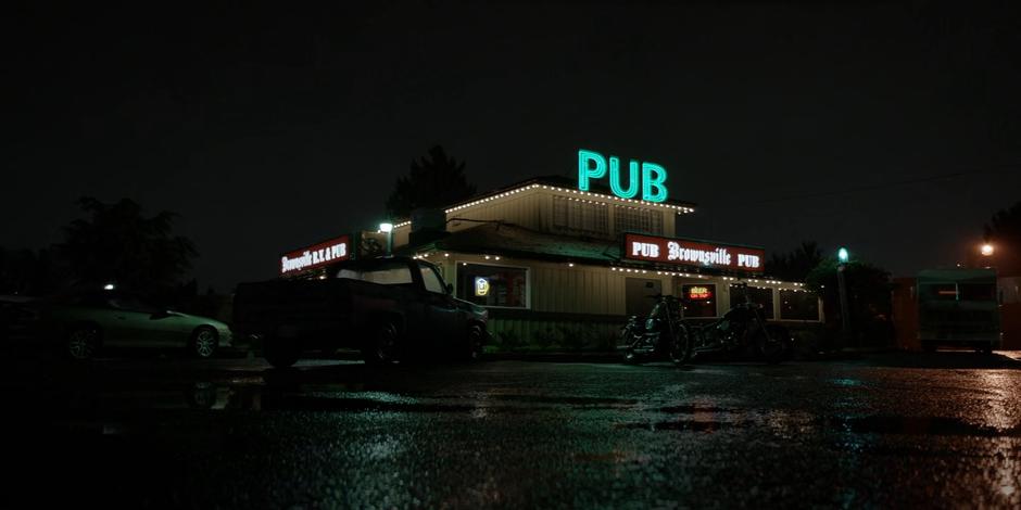 Establishing shot of the pub at night with the stolen RV parked to the side.