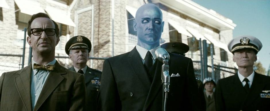 Dr. Manhattan holds a press conference outside the base after his reappearance.