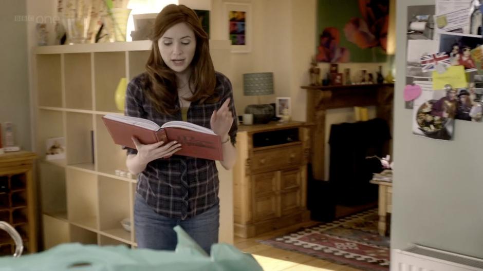 Amy reads some of the Doctor's escapades aloud to Rory.