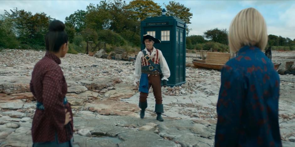 Yaz and the Doctor look at Dan in the pirate outfit Yaz put together for him.