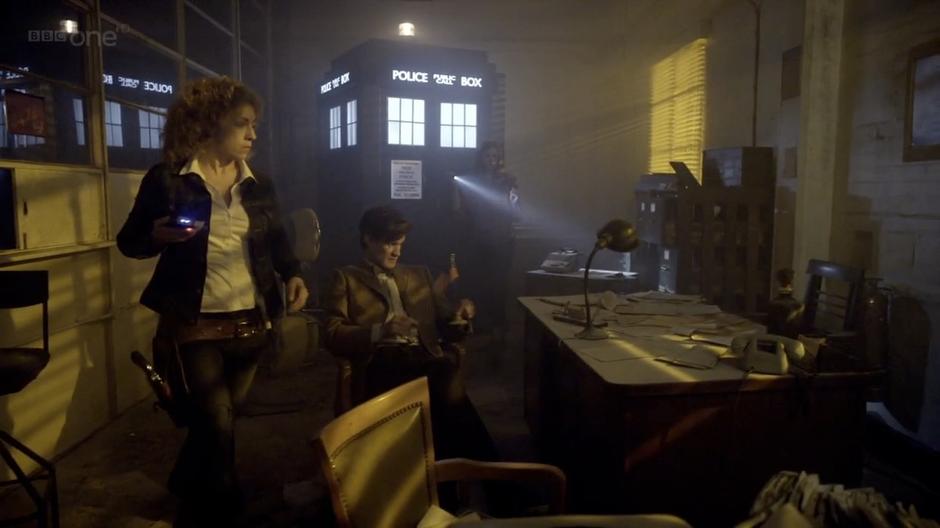 The Doctor and his friends look around after arriving at the warehouse.