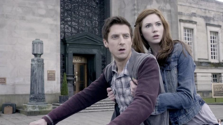 Amy and Rory watch the hotel guests flee.