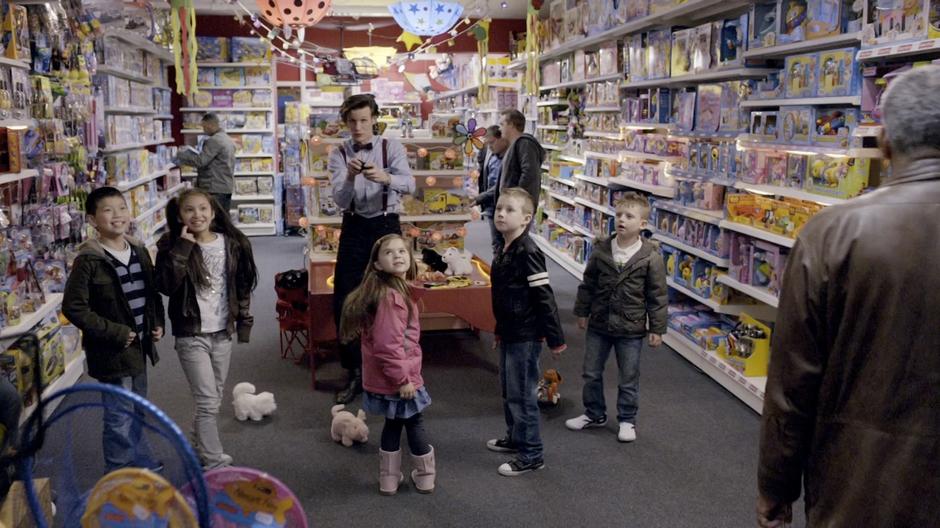 The Doctor entertains kids in the toy store at which he works.