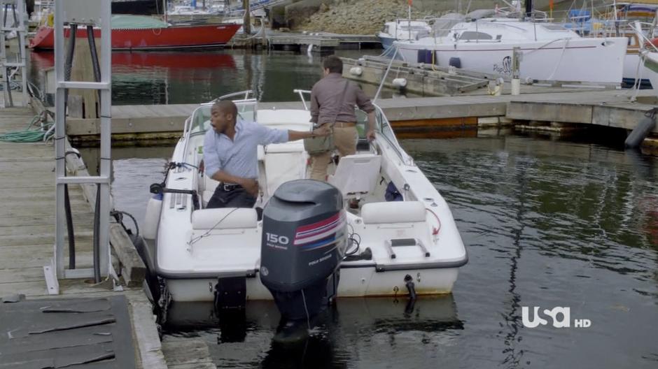Gus unties the boat and Shawn attempts to drive it away from the dock.