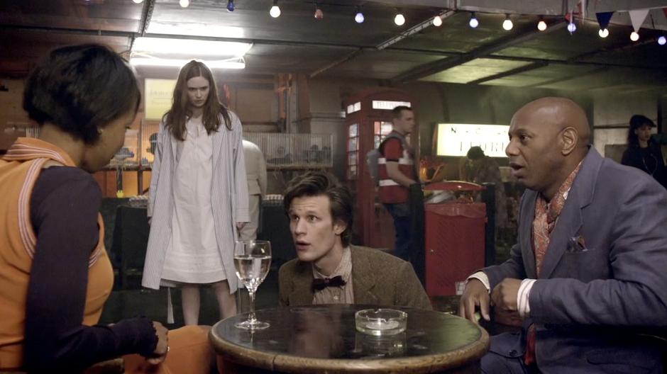 The Doctor contemplates a glass of water.