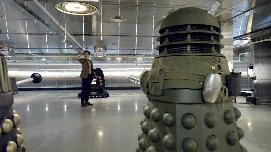 The Doctor threatens the Daleks with a cookie.