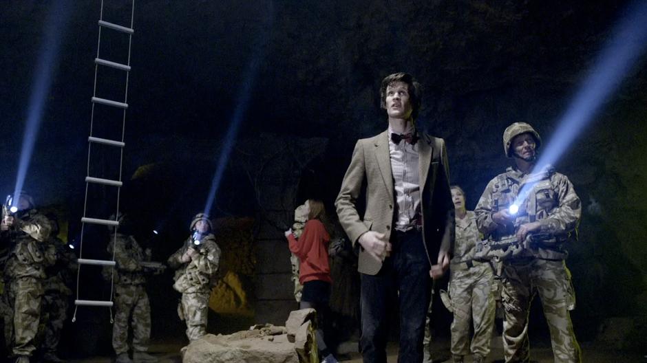 The Doctor and the group look up at the vast maze.