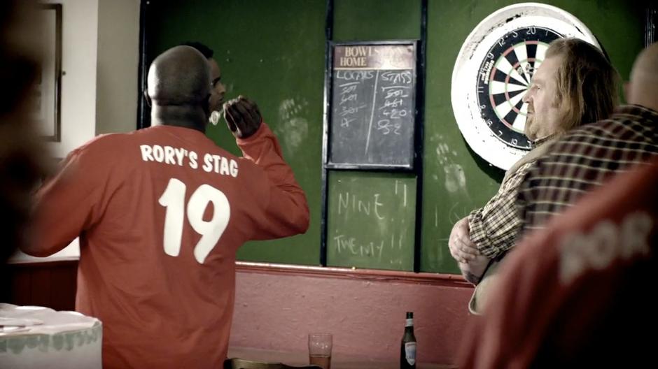 Some of Rory's friends play darts during the party.
