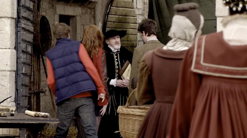 Amy, Rory, and the Doctor are stopped by a customs agent while trying to get into the city.