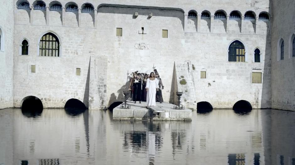 Isabella is pushed towards the pier.