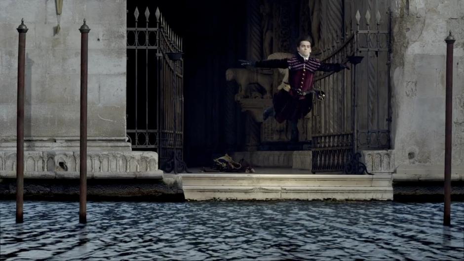 Francesco dives into the water beside the mansion.