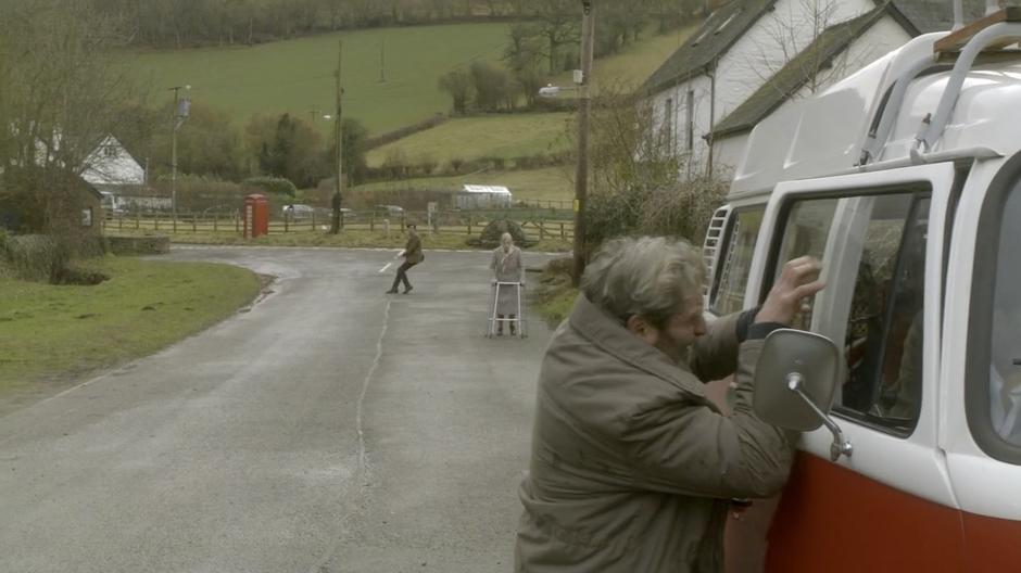 The Doctor sees an old man trying to break into a van.