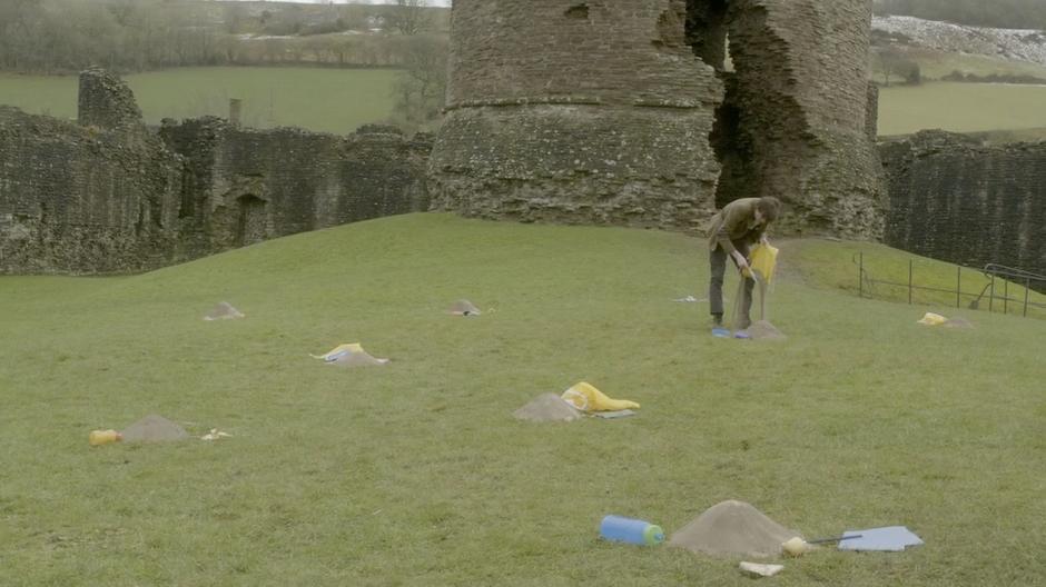 The Doctor examines the piles of dust where the children used to be.