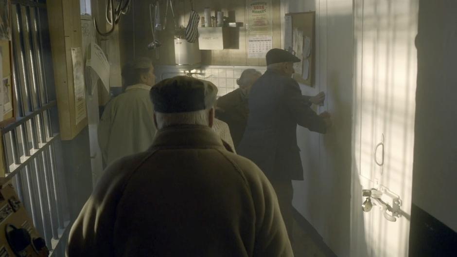 An elderly mob attempts to get into the walk-in freezer.