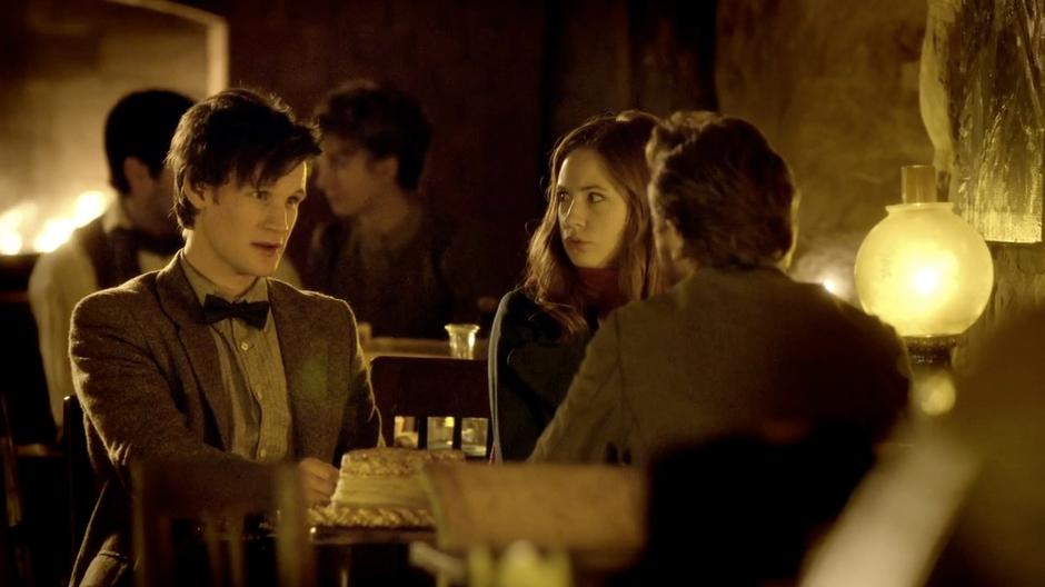 Amy, Vincent and the Doctor talk in the cafe.