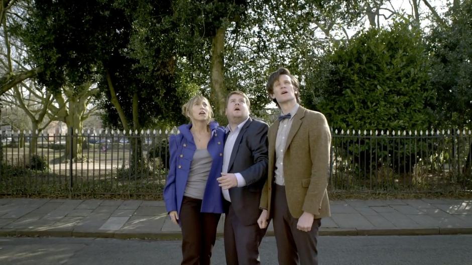 Craig, Sophie, and the Doctor watch the upper floor of the flat disappear.