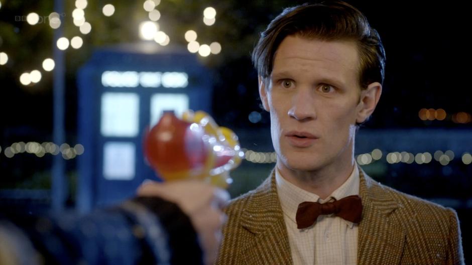 Amy threatens the Doctor with a water pistol.
