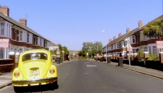 Rose and Mickey pull to a stop on Clive's street.