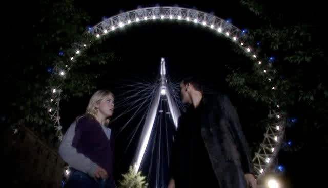 Rose and the Doctor talk below the London Eye.