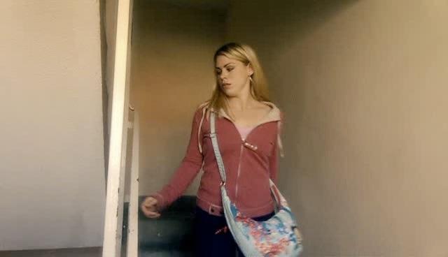 Rose walks down the stairs outside her flat.