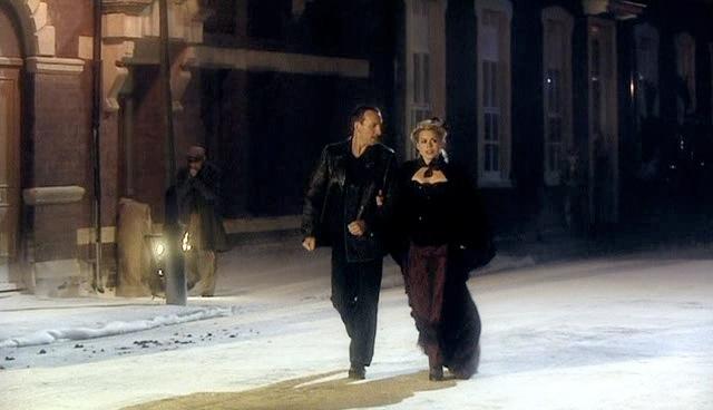 Rose and the Doctor stroll through the snowy streets.