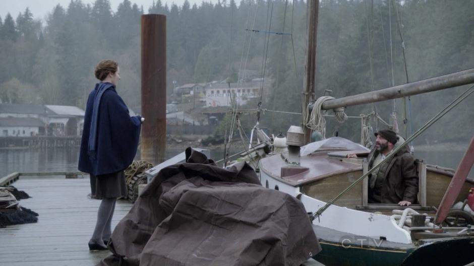 Astrid presents her pie to Leroy at his boat.