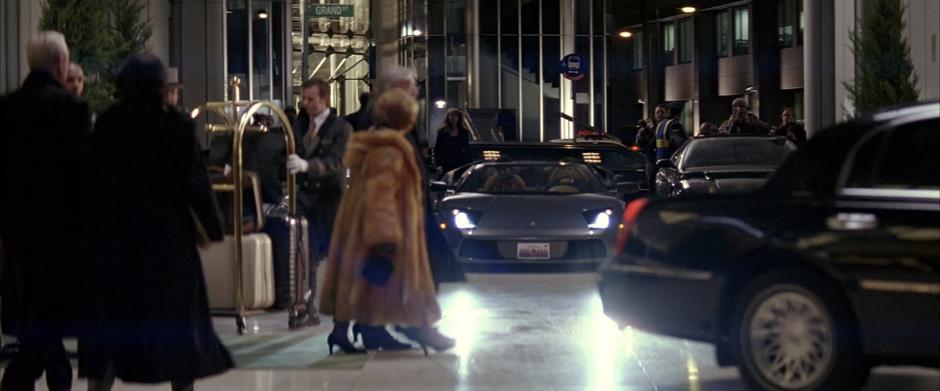 Bruce drives up to the hotel with his two female companions.