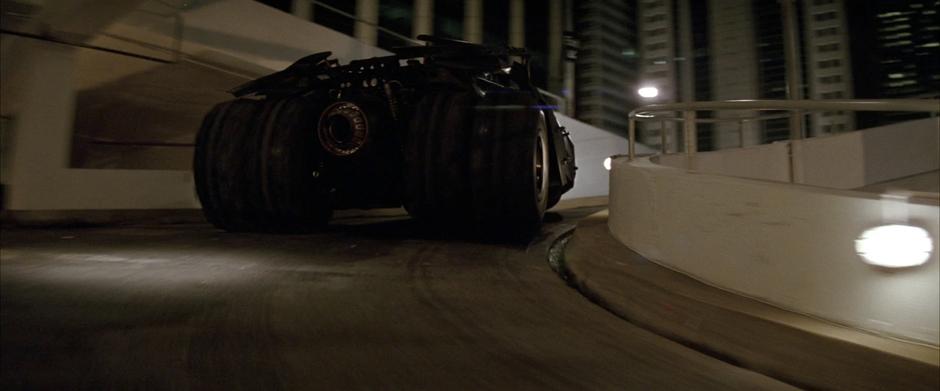 Batman drives up the parking garage ramp.