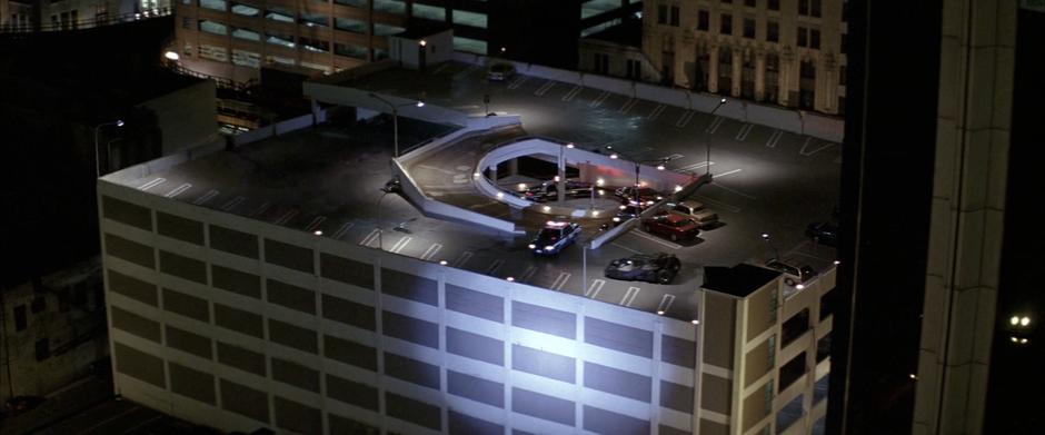 The police follow the Batmobile to the roof of the parking garage.