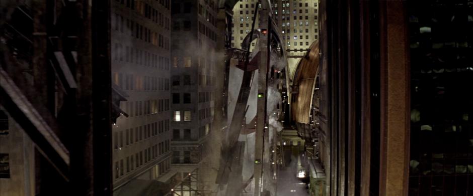 The monorail track collapses outside of the Wayne Enterprises tower.