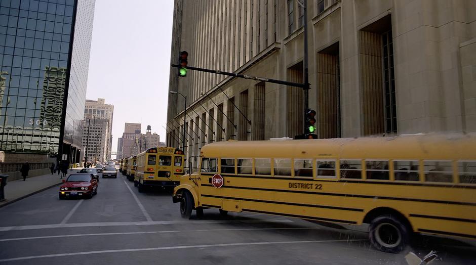 The Joker drives a school bus out of the bank.