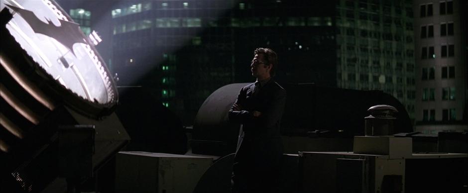 Jim Gordon waits with the Batsignal atop the police station.