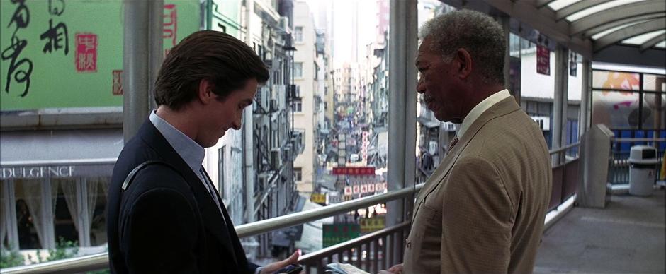 Bruce Wayne and Lucius Fox talk about the plan to retrieve Lau.