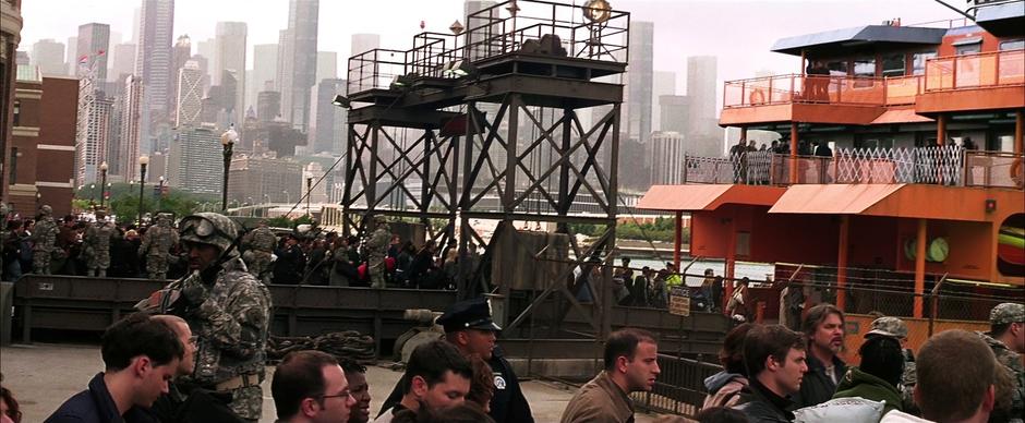 Gotham citizens load onto ferries in an attempt to escape the city.