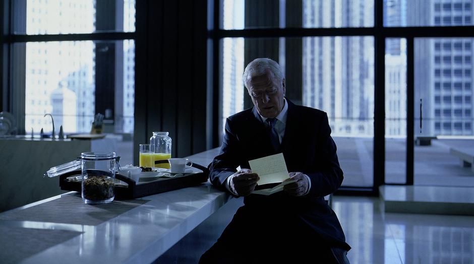 Alfred reads Rachel Dawes's note to Bruce Wayne.