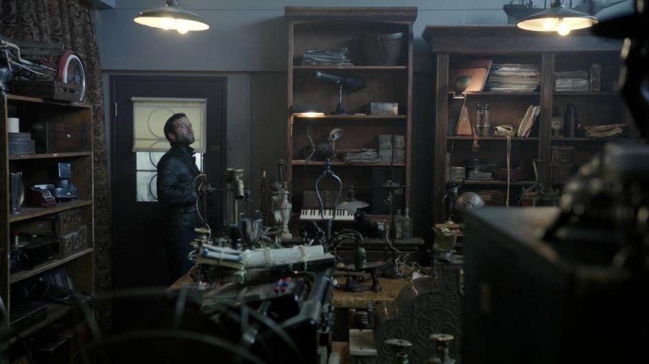 August searches the back room of Mr. Gold's shop.