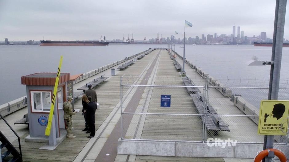 Fauxlivia, Lincoln, and Walter go through the checkpoint on the ferry dock.