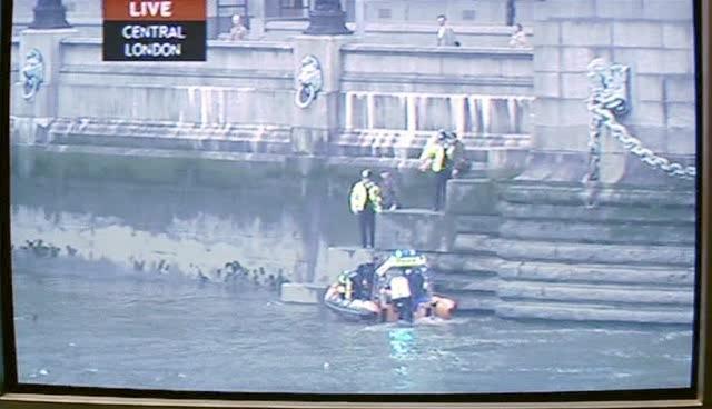 Alien remains are removed from the Thames by rescue crews.