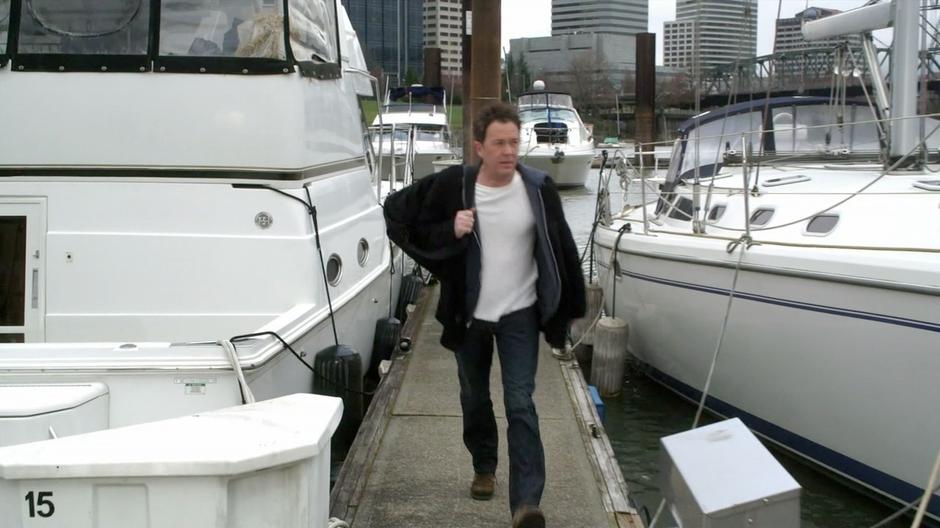 Nate gets off his boat and walks down the jock.