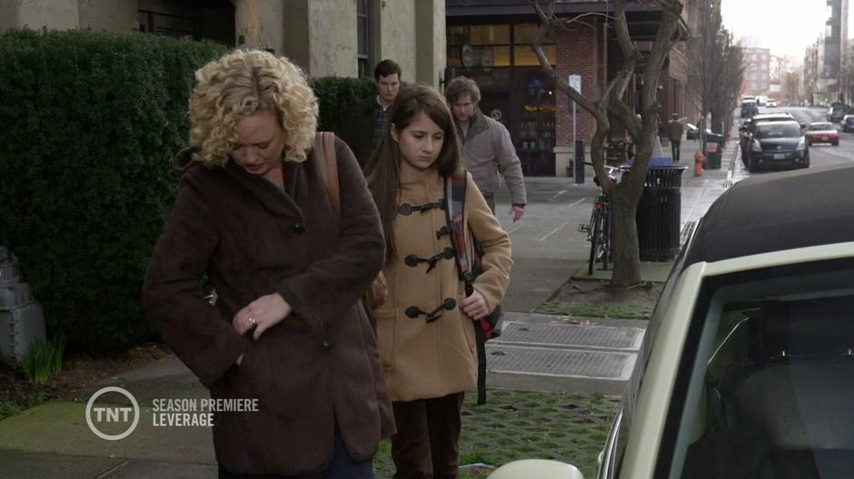 Anne and Jenny Sanders walk to their car and are approached by thugs across from Leverage HQ.
