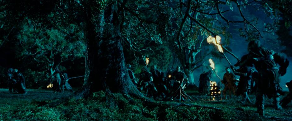 Saruman's orcs prepare to cut down one of the trees in the gardens.