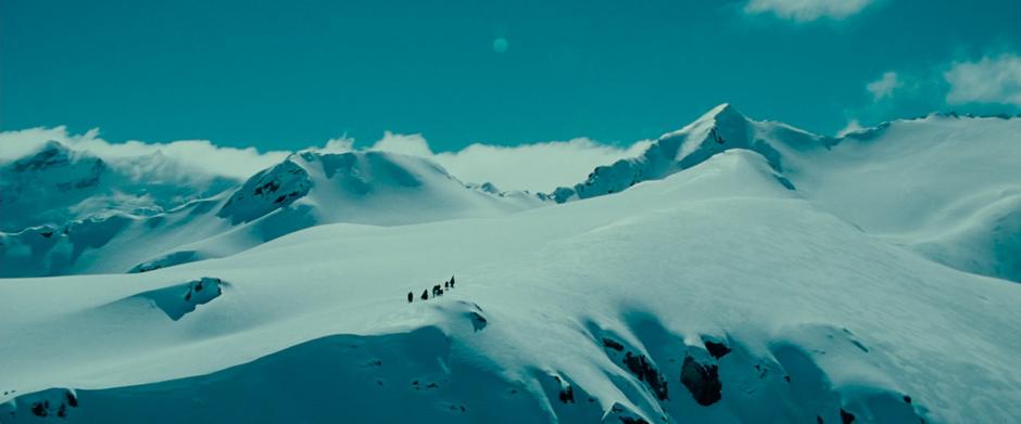 The Fellowship treks through the snow up the slopes of Caradhras.