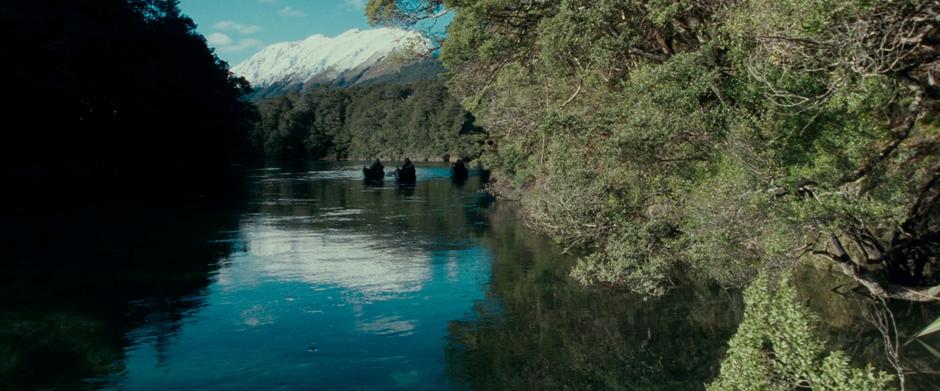 The Fellowship travels down the Anduin just outside Lothlórien.